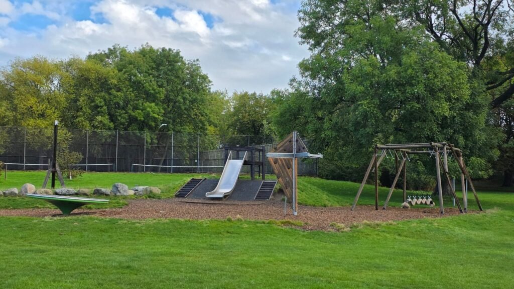 Natural play area with mound slide and swings at Princes Park Natural play area with mound slide and swings at Princes Park