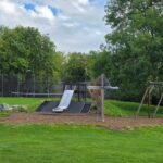 Natural play area with mound slide and swings at Princes Park Natural play area with mound slide and swings at Princes Park