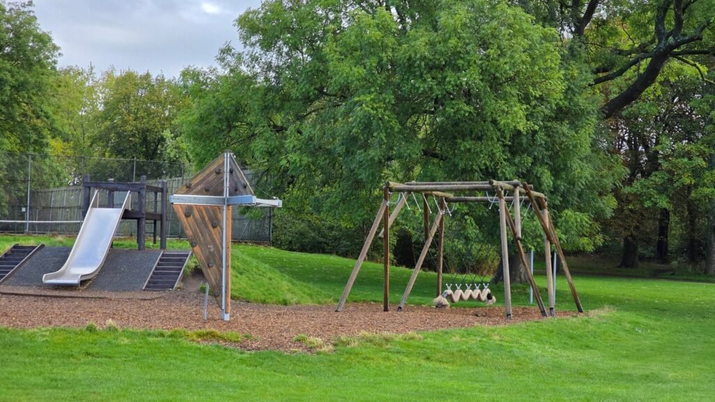 Slide mound and wooden play frame at Princes Park, Liverpool Slide mound and wooden play frame at Princes Park, Liverpool