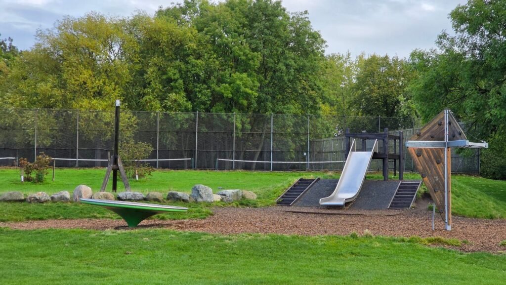 Wooden swings and mound slide at Princes Park Playground Wooden swings and mound slide at Princes Park Playground